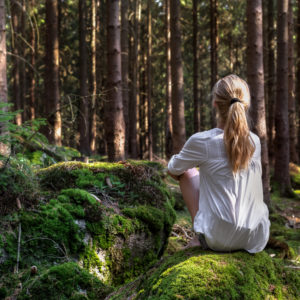 Woman,Sitting,In,Green,Forest,Enjoys,The,Silence,And,Beauty