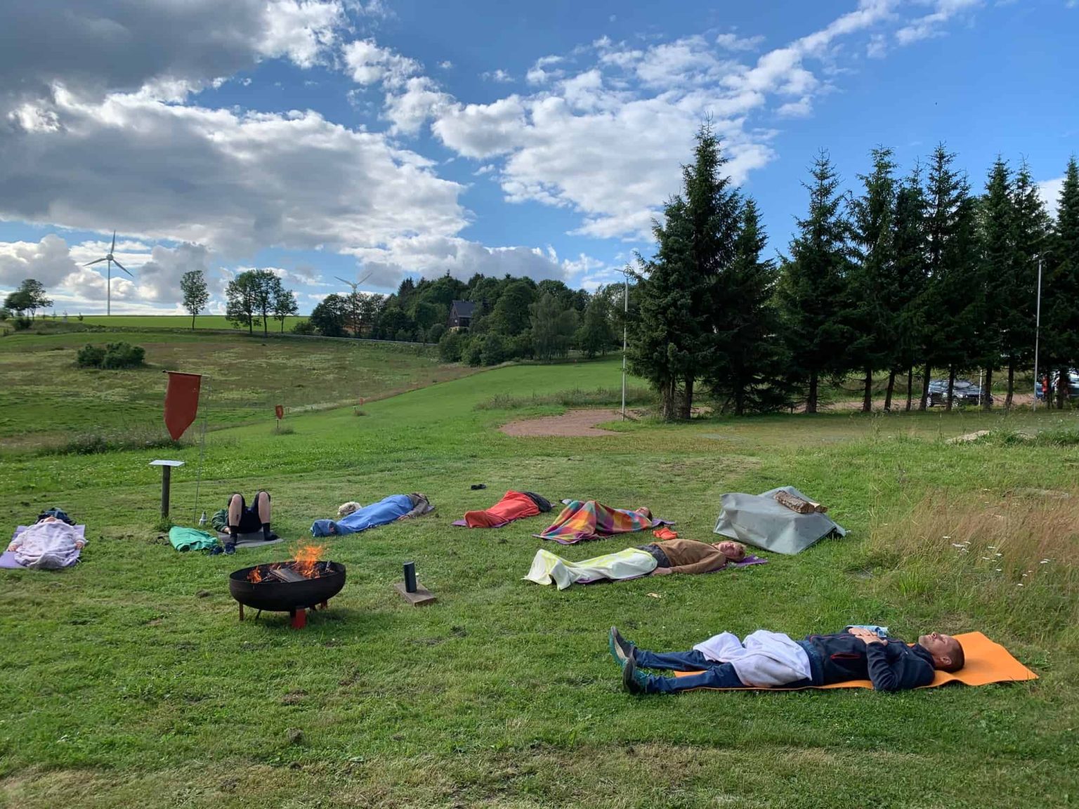 Wim Hof breathing exercise on the meadow in the Ore Mountains