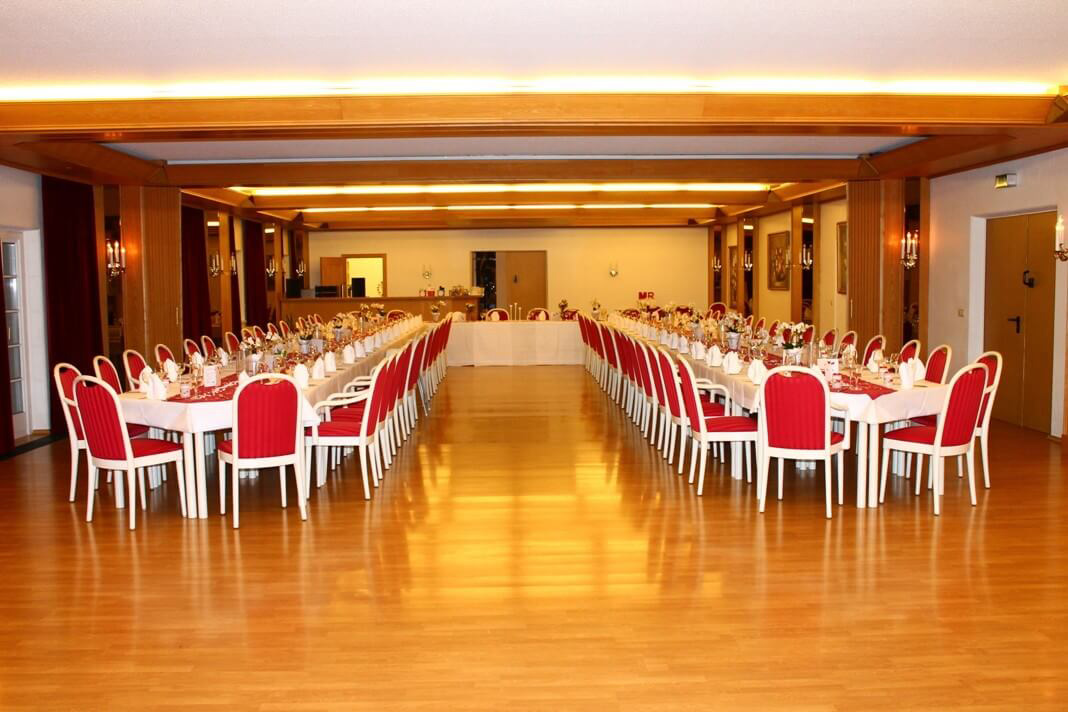 Large hall with long, festively laid tables