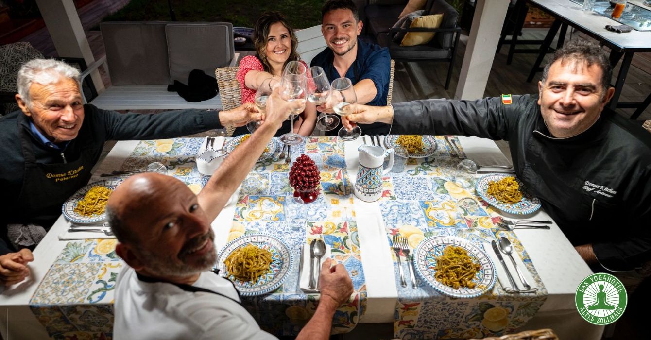 Guests and chef raising a toast at a cooking class at the Zollhaus